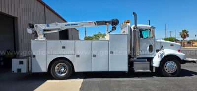 Service/Utility truck with a crane, 2003 Peterbilt 330, side compartments and boom crane visible