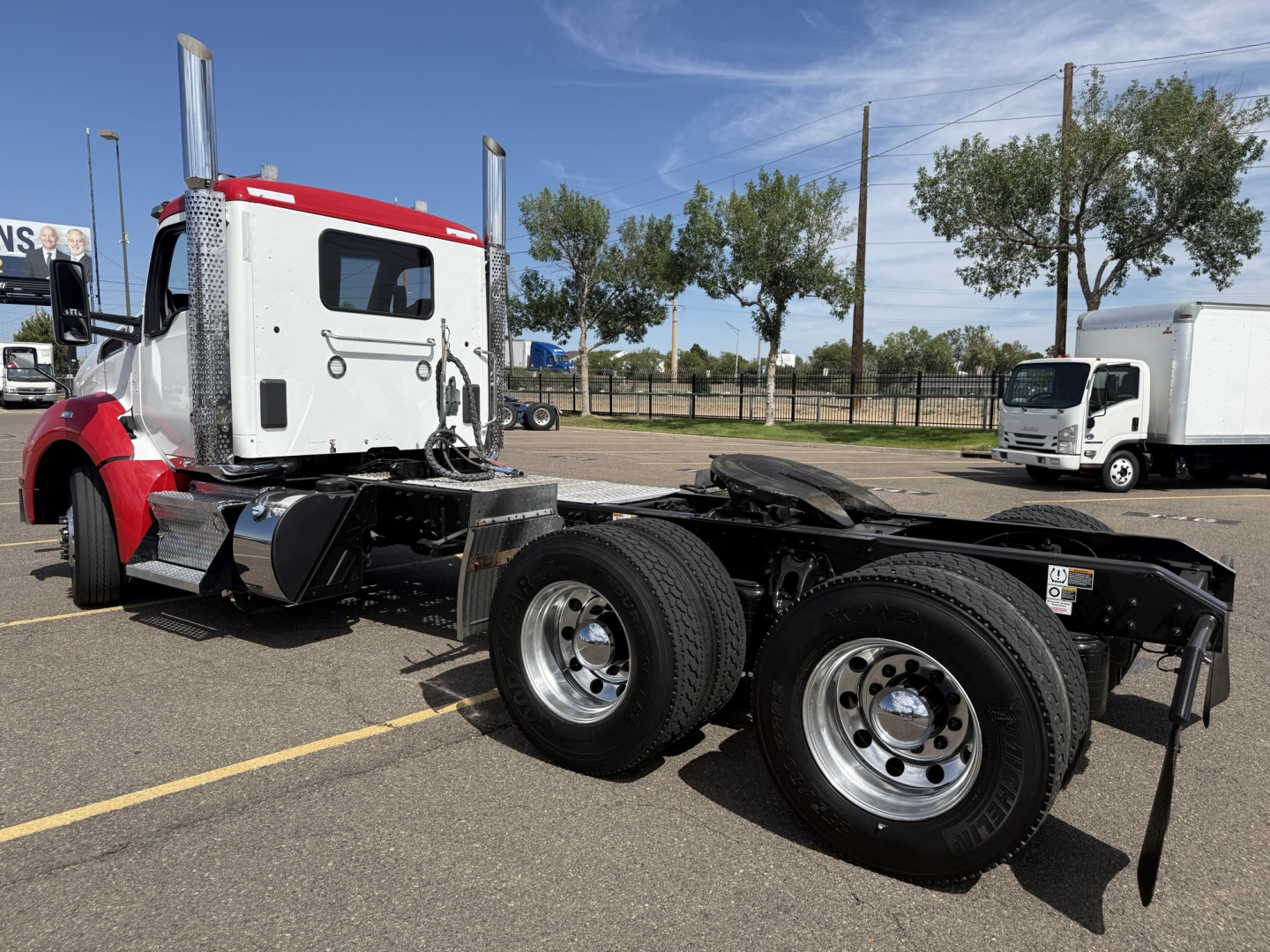 Kenworth T880 conventional daycab chassis view showing dual rear axles and fuel tanks.