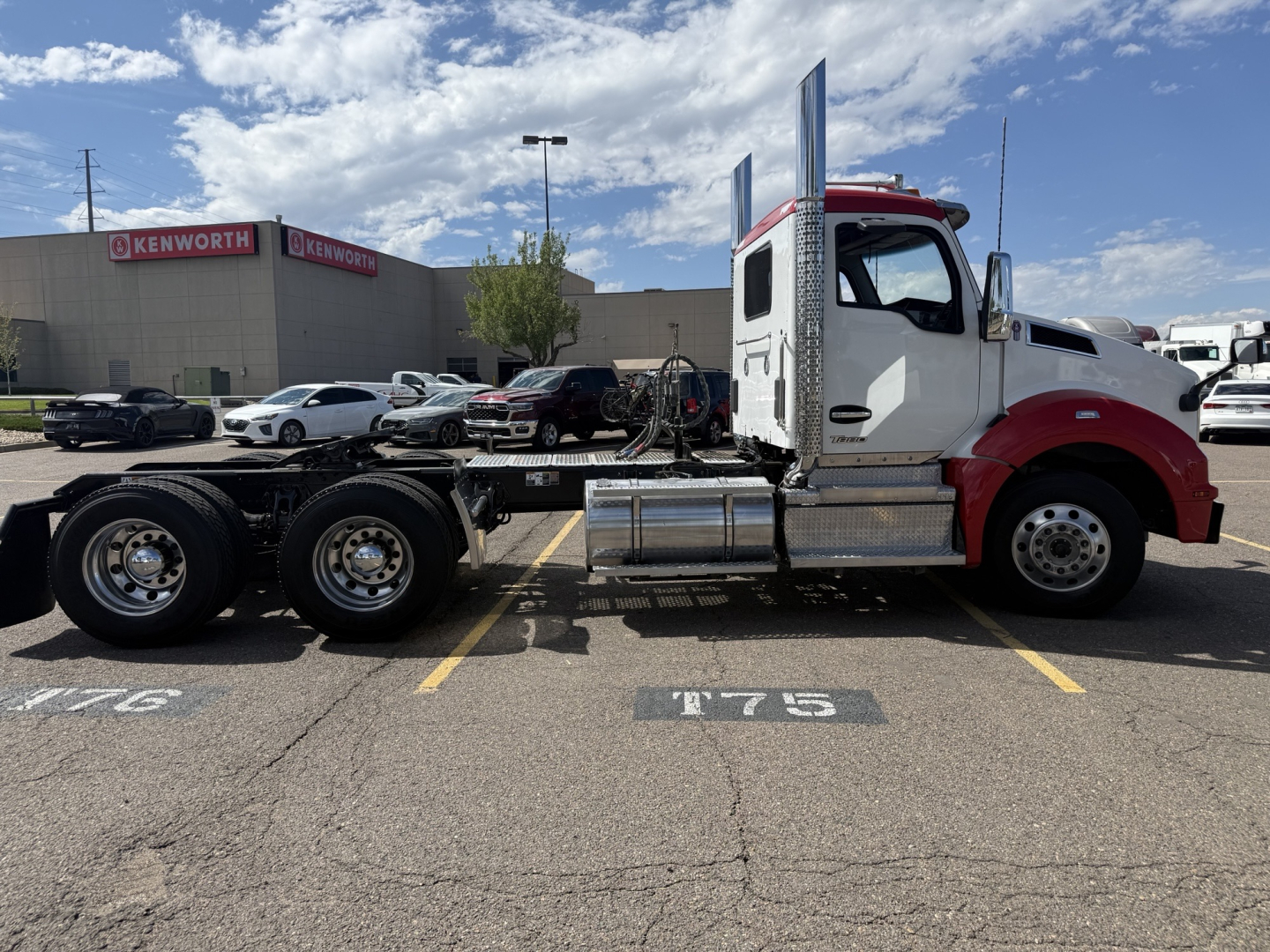 Kenworth T880 tractor in a parking lot side profile showing chassis and cab details with dual rear axles.