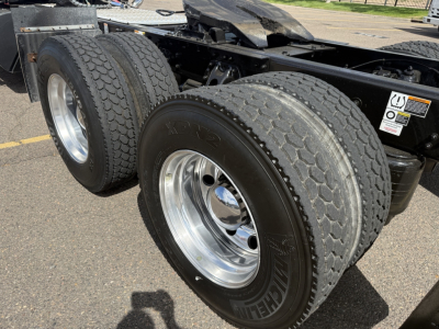 Kenworth T880 chassis rear view showing dual rear axles with Michelin tires and polished chrome wheels.