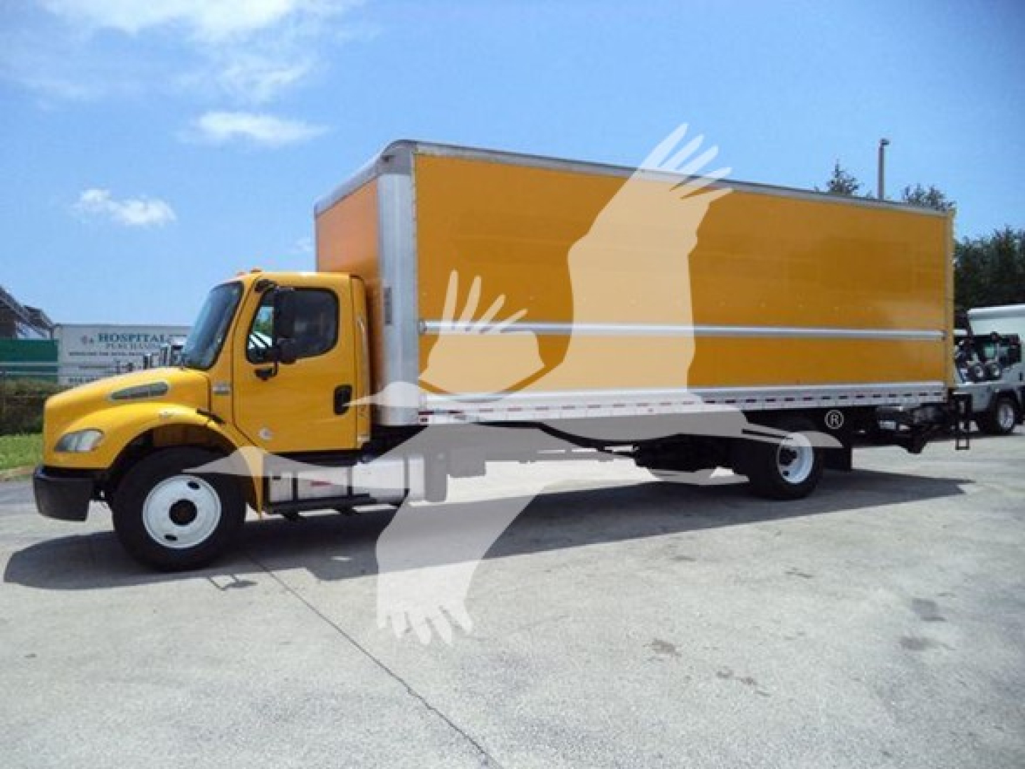 Freightliner M2 106 box truck side view showing yellow cab and orange box with white chassis and wheels.
