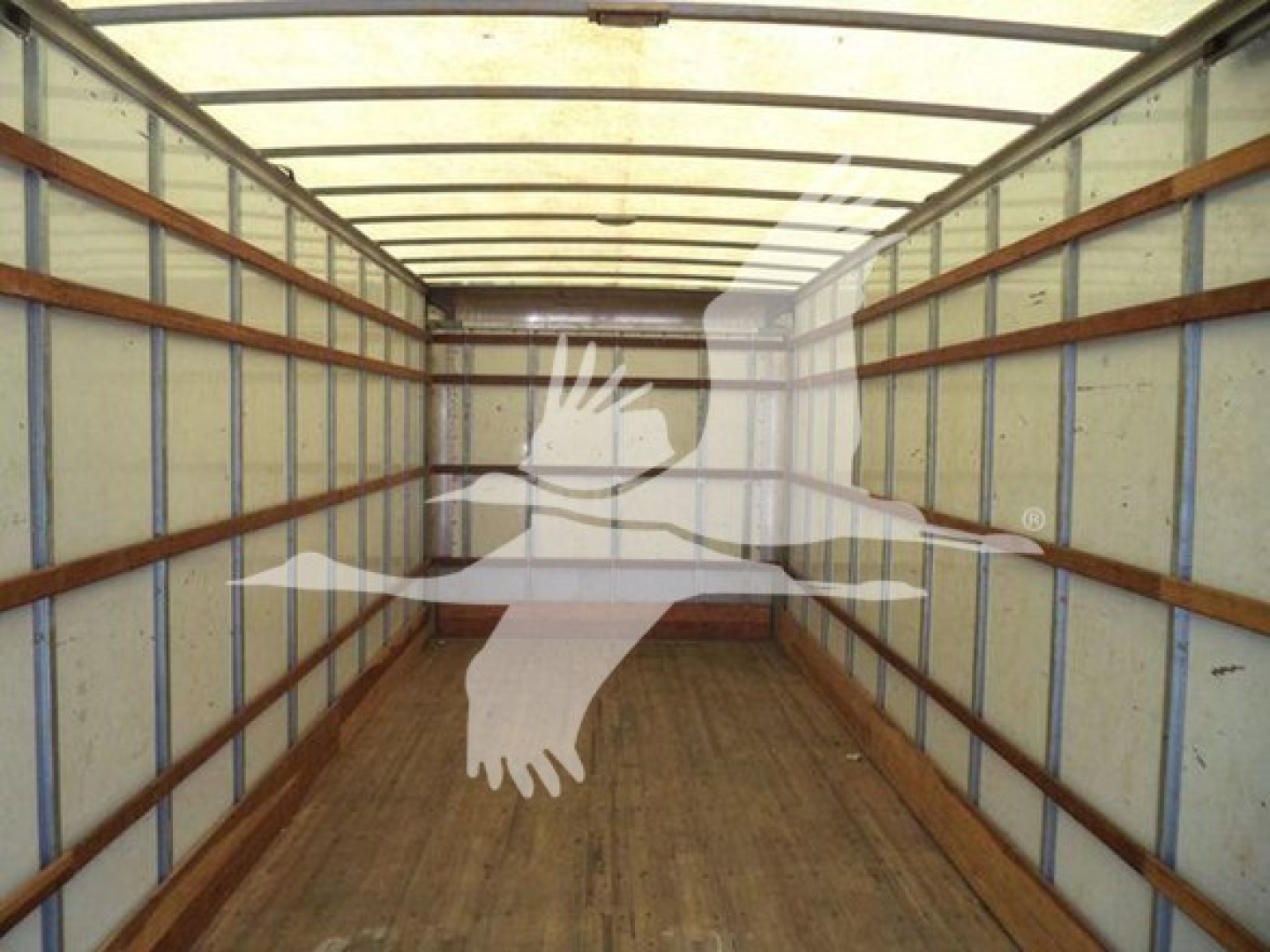 Commercial truck cargo area interior of a 2019 Freightliner M2 106 box truck showing wooden floor and steel ribs.