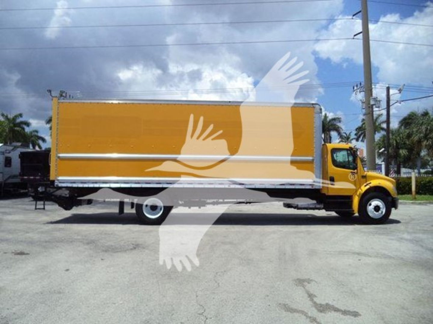 Box truck side view showing a yellow Freightliner M2-106 with a large cargo box. Side text not legible.