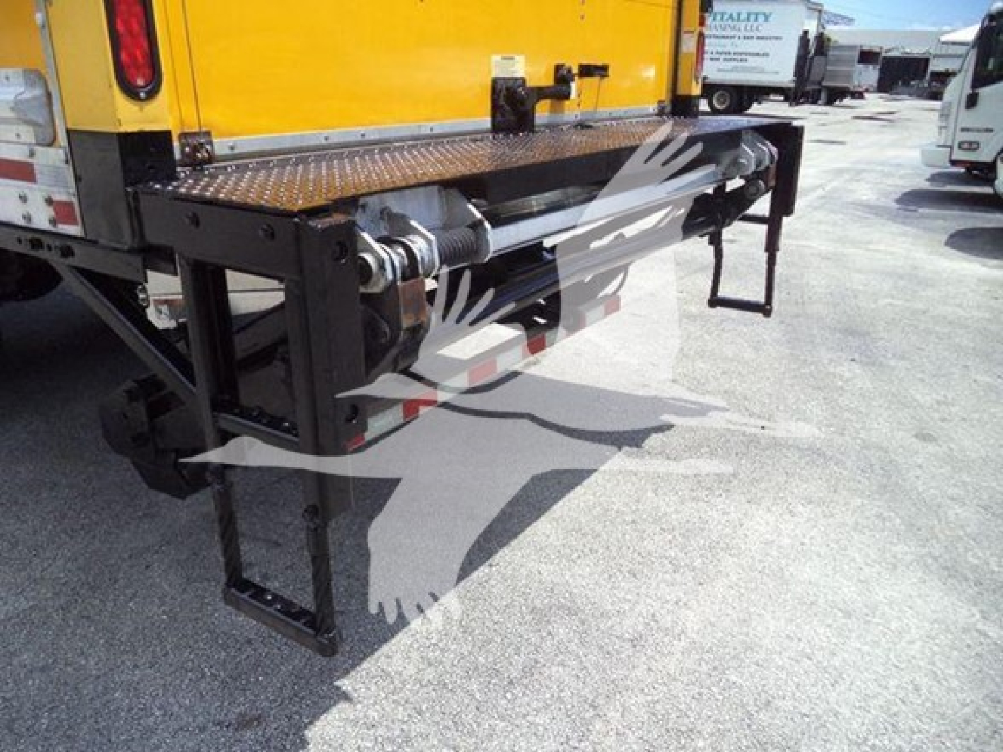 Rear of a Freightliner M2 106 box truck showing liftgate and bumper hardware.