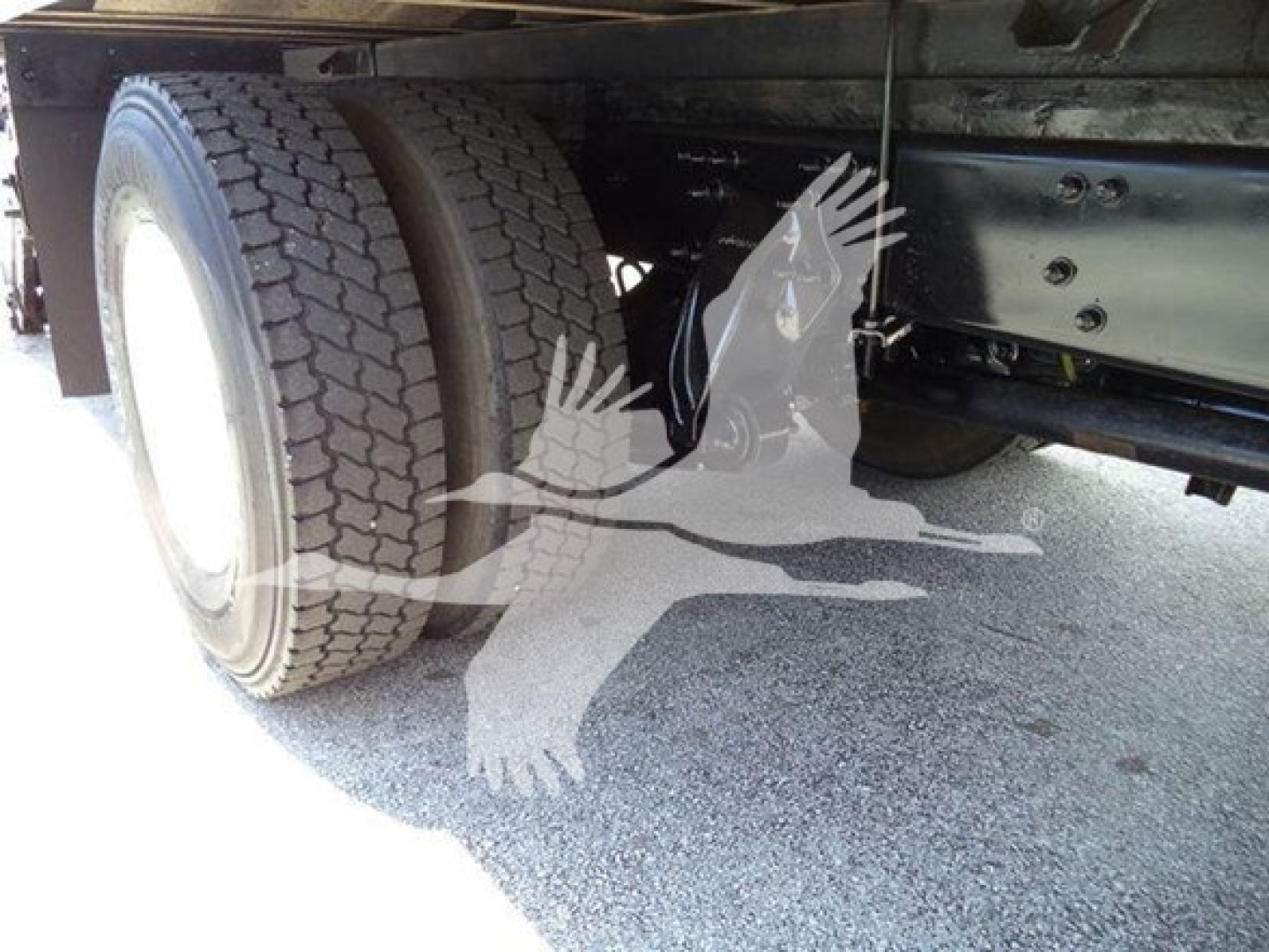 Freightliner M2 106 rear dual wheels and chassis frame showing tire tread and undercarriage components.