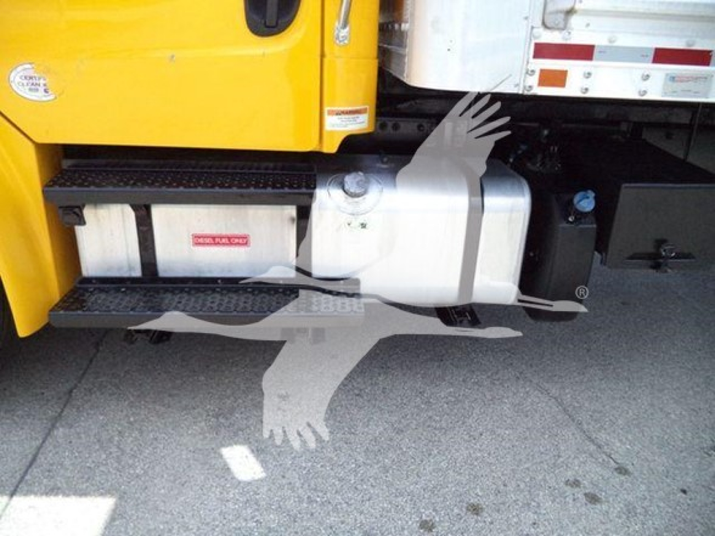 Freightliner M2 106 side view showing fuel tank and steps under yellow cab