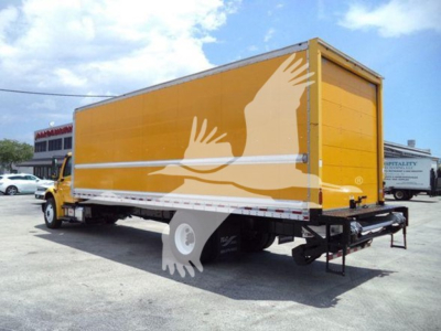 Freightliner M2 106 box truck showing yellow cargo body with white illustrated hands graphic.