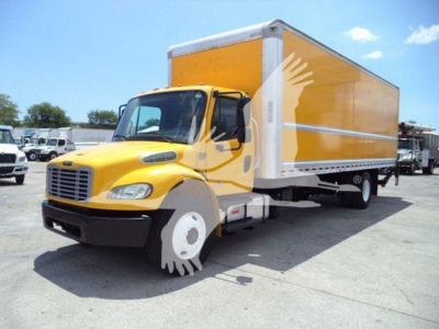 Freightliner M2 106 box truck with yellow cab and orange cargo box, side view, showing the front grille and wheel.