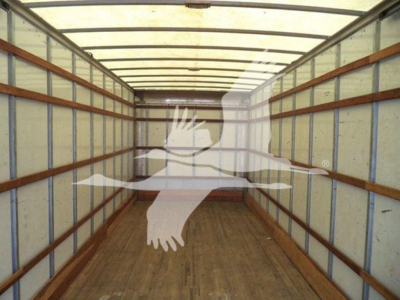 Commercial truck cargo area interior of a 2019 Freightliner M2 106 box truck showing wooden floor and steel ribs.