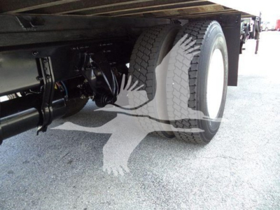 Freightliner M2 106 chassis showing dual rear wheels and undercarriage components; view from passenger side near rear axle.