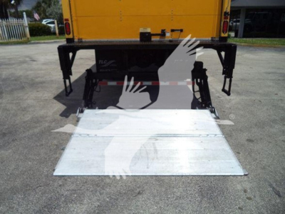 Rear view of a Freightliner M2 106 with a lowered aluminum ramp at the back, stock number TH6807, box truck in view.