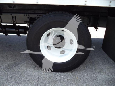 Freightliner M2 106 wheel and tire close-up showing white steel wheel and black tire underataxbed frame