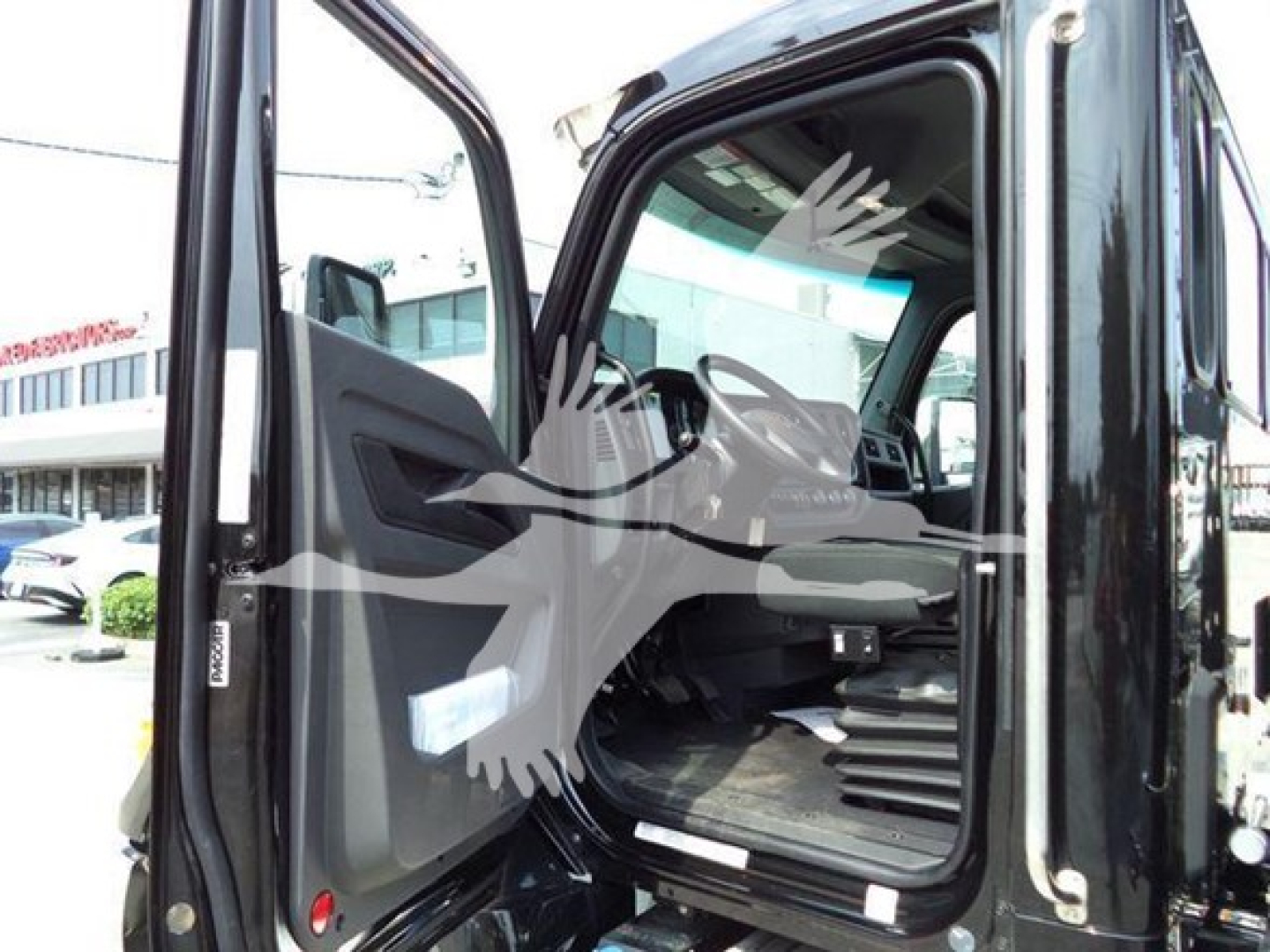Kenworth T280 cab interior view through open door showing steering wheel and dashboard in a new rollback truck