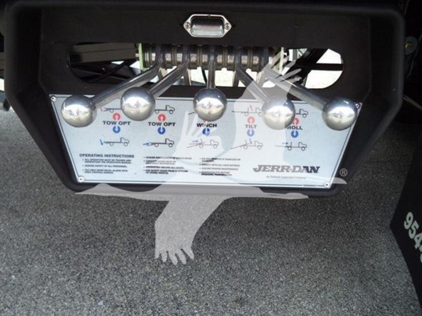Kenworth T280 rollback control panel with five round knobs and instruction diagram, displayed in-bed image. Brand: Jerr-Dan at bottom right.