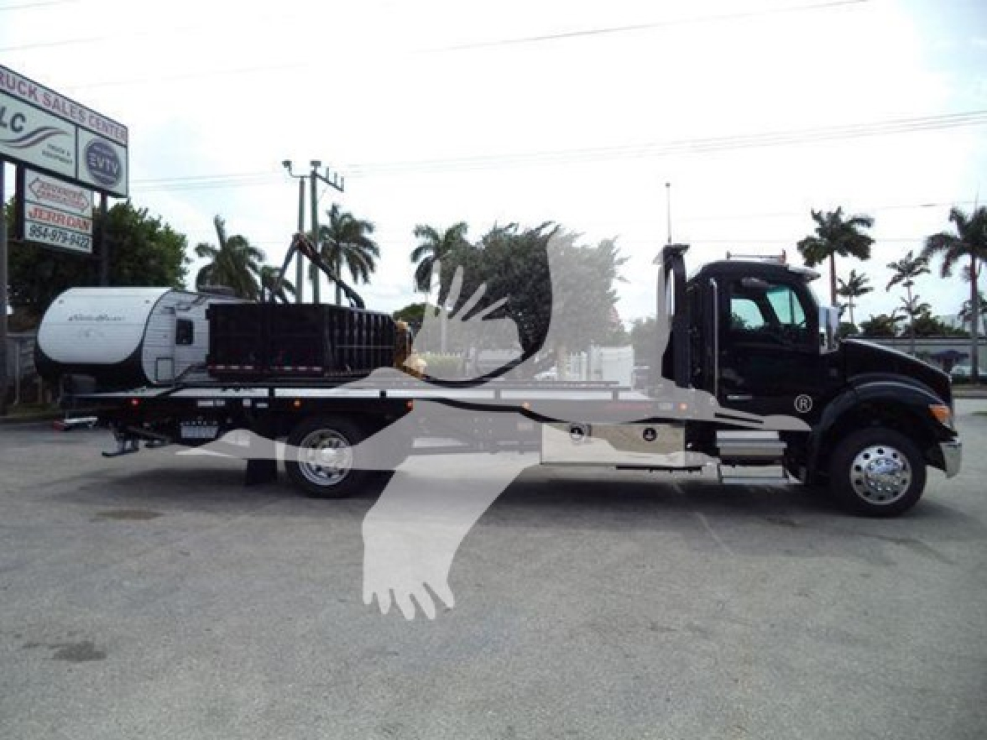 Kenworth T280 rollback truck shown in side profile with a tanker trailer attached.
