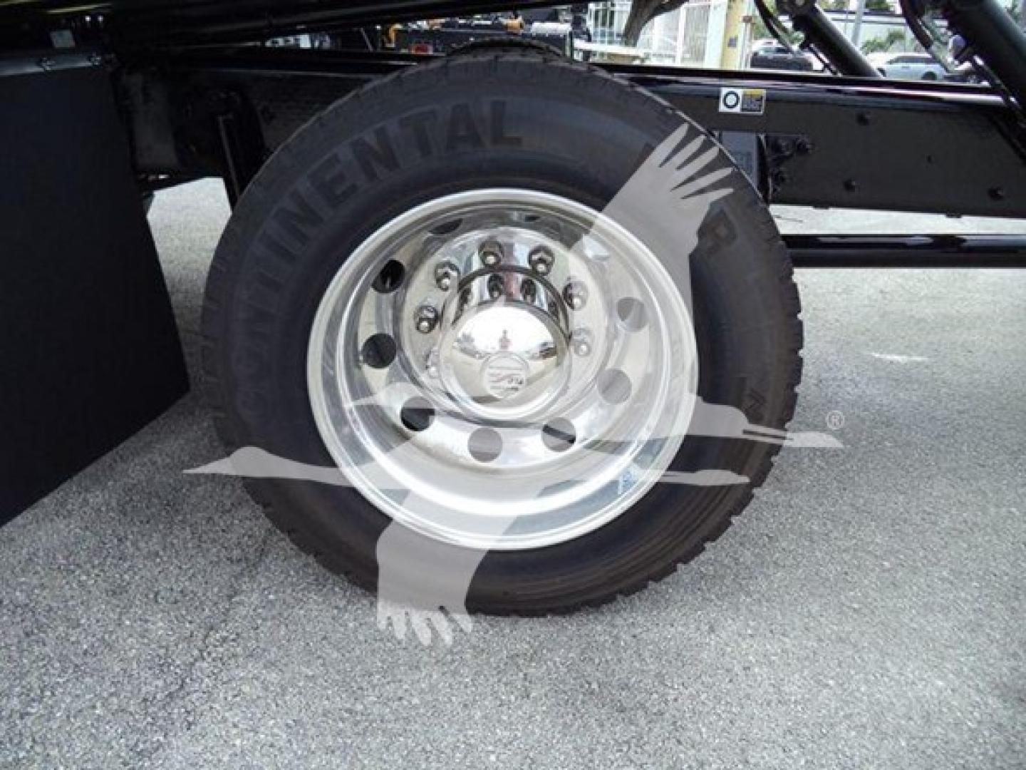 Truck wheel and tire on Kenworth T280 undercarriage; Continental tire with chrome hub; visible bolt pattern and steel rim.