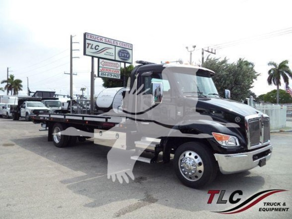 Kenworth T280 rollback tow truck in a dealership lot showing front grille, cab and flatbed with TLC Truck & Equipment logo on door and VIN/stock information sign in background.