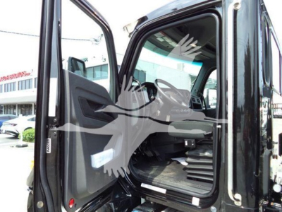 Kenworth T280 cab interior view through open door showing steering wheel and dashboard in a new rollback truck