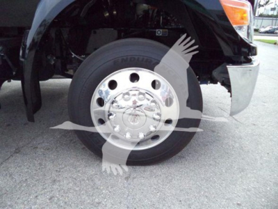 Kenworth T280 front wheel and fender view with chrome wheel, tire, and portion of bumper.