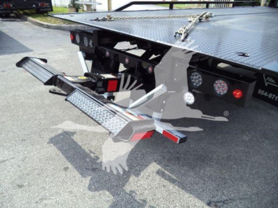 Kenworth T280 rollback truck platform showing fold-out side steps and rear deck with diamond plate surface.