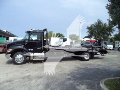 Kenworth T280 rollback truck in side view showing flatbed and tow equipment with cab and engine compartment visible.