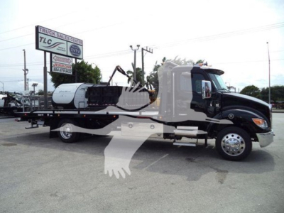 Kenworth T280 rollback truck in a dealership lot with VIN 2NK3HM6XXSM140823 and stock J40823.