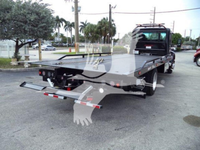 Kenworth T280 rollback tow truck rear view with flatbed and lift gates visible.