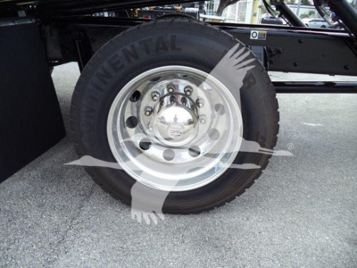 Truck wheel and tire on Kenworth T280 undercarriage; Continental tire with chrome hub; visible bolt pattern and steel rim.