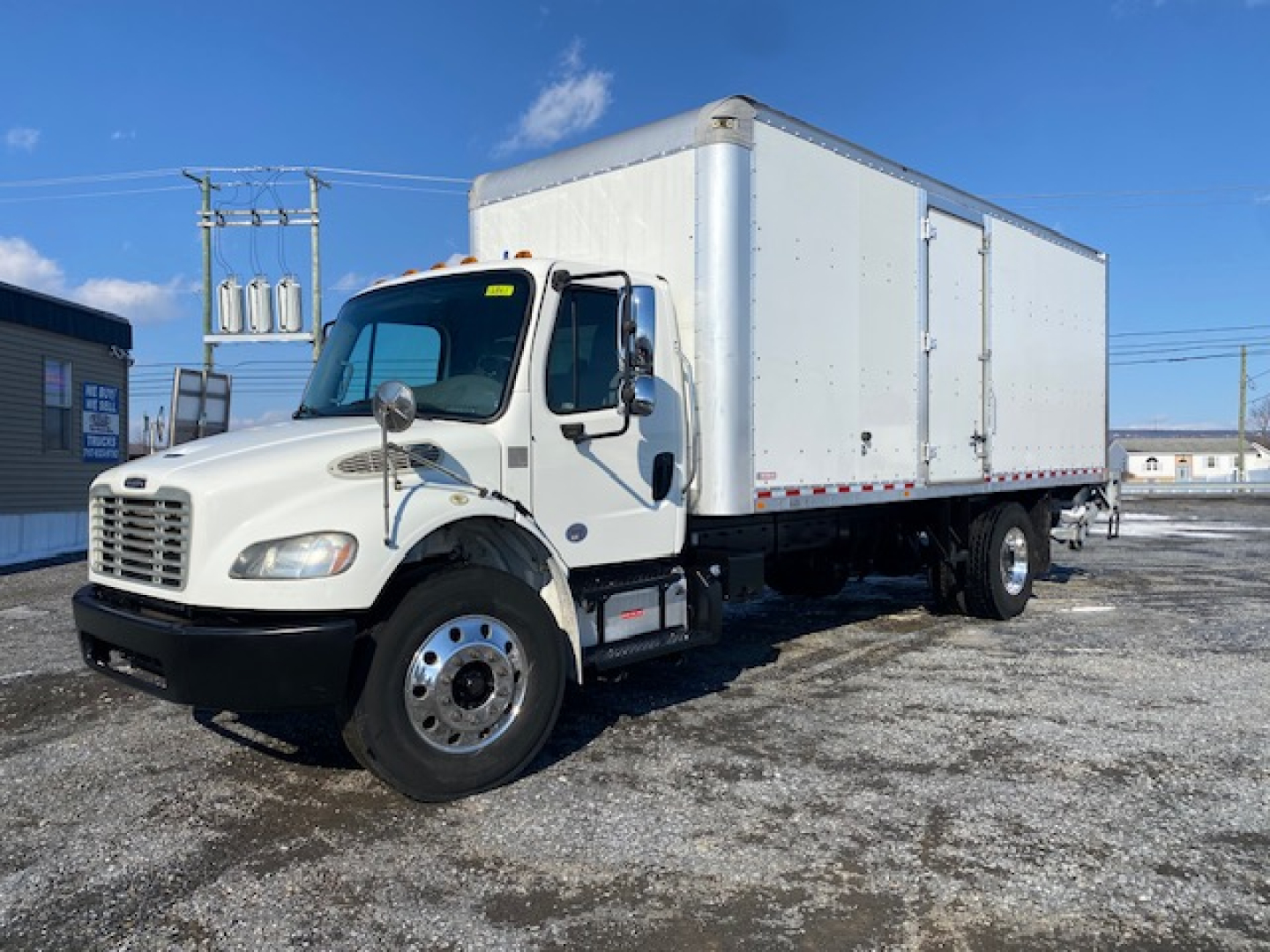 Box truck: 2019 Freightliner M2 106 box truck with white cab and large white cargo box, side view showing dual rear wheels, chrome mirrors, and front grille.