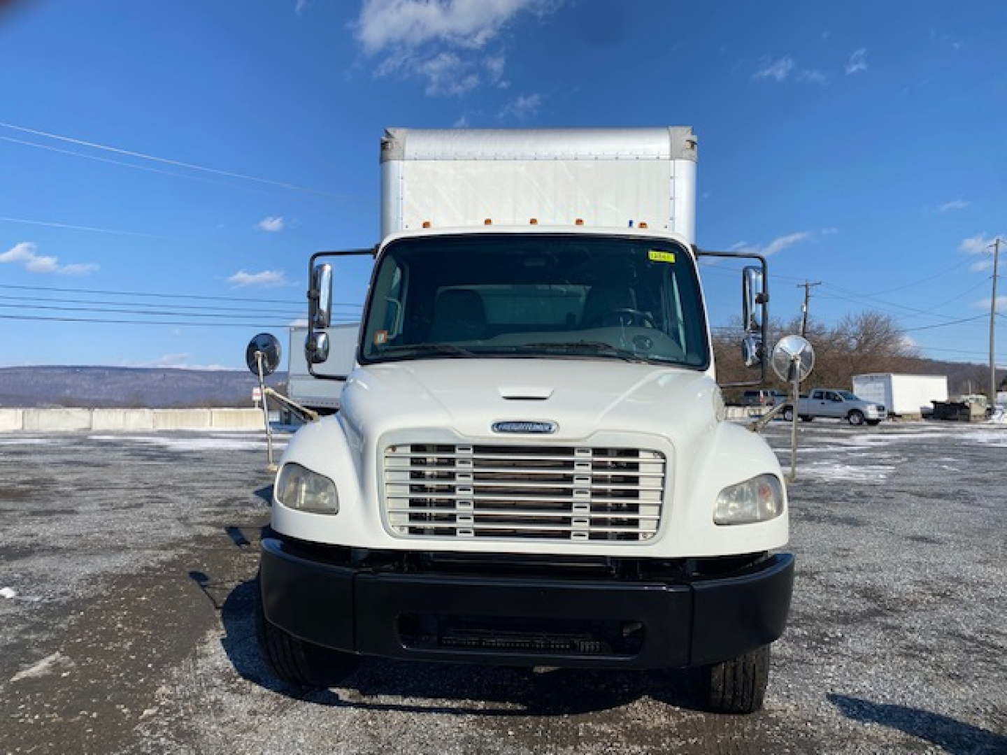 Front view of a white 2019 Freightliner M2 106 box truck with large grille, mirrors, and cargo box overhead. VIN 3ALACWFC2KDKM2318 not visible in image.