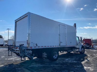 Box truck from a right-rear angle showing cargo box, chassis, and cab of a Freightliner M2 106 used vehicle.