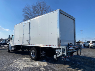 Freightliner M2 106 box truck side/rear view showing cargo box and rear bumper.