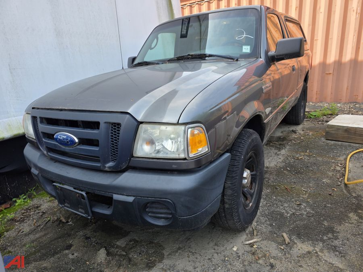 Ford Ranger pickup truck 2008 with cap, front-left view, gray body, black bumper, round headlights, Ford emblem on grille, 4x4 badge not visible.