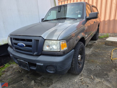 Ford Ranger pickup truck 2008 with cap, front-left view, gray body, black bumper, round headlights, Ford emblem on grille, 4x4 badge not visible.