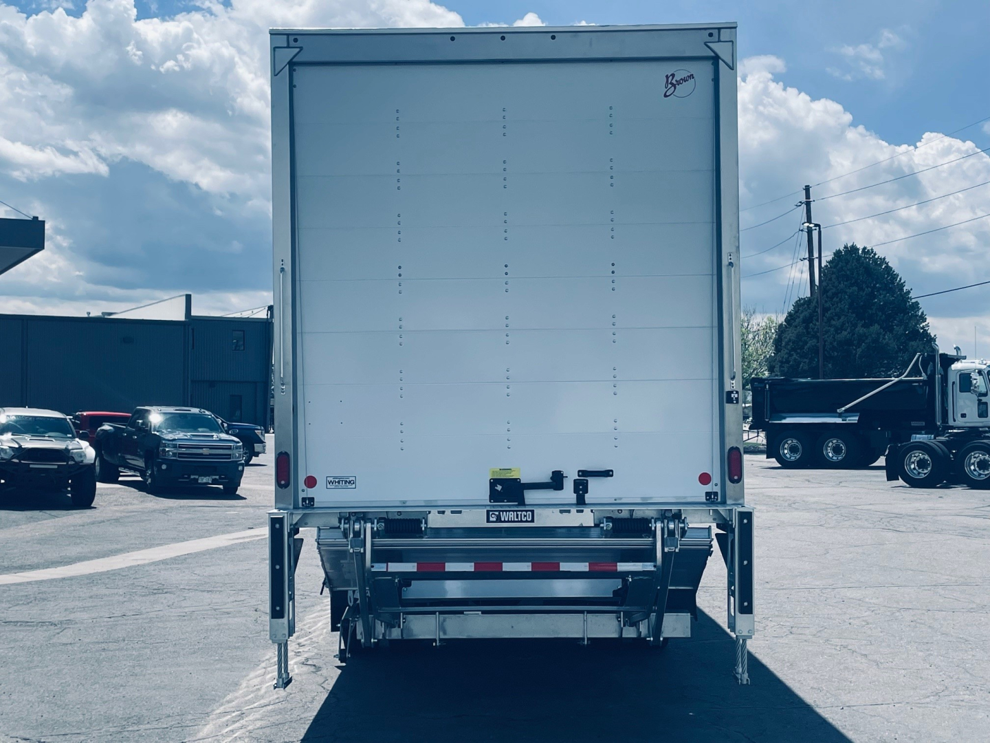 Rear view of a 2026 Mack MD6 box truck showing enclosed cargo area and rear underride guard.