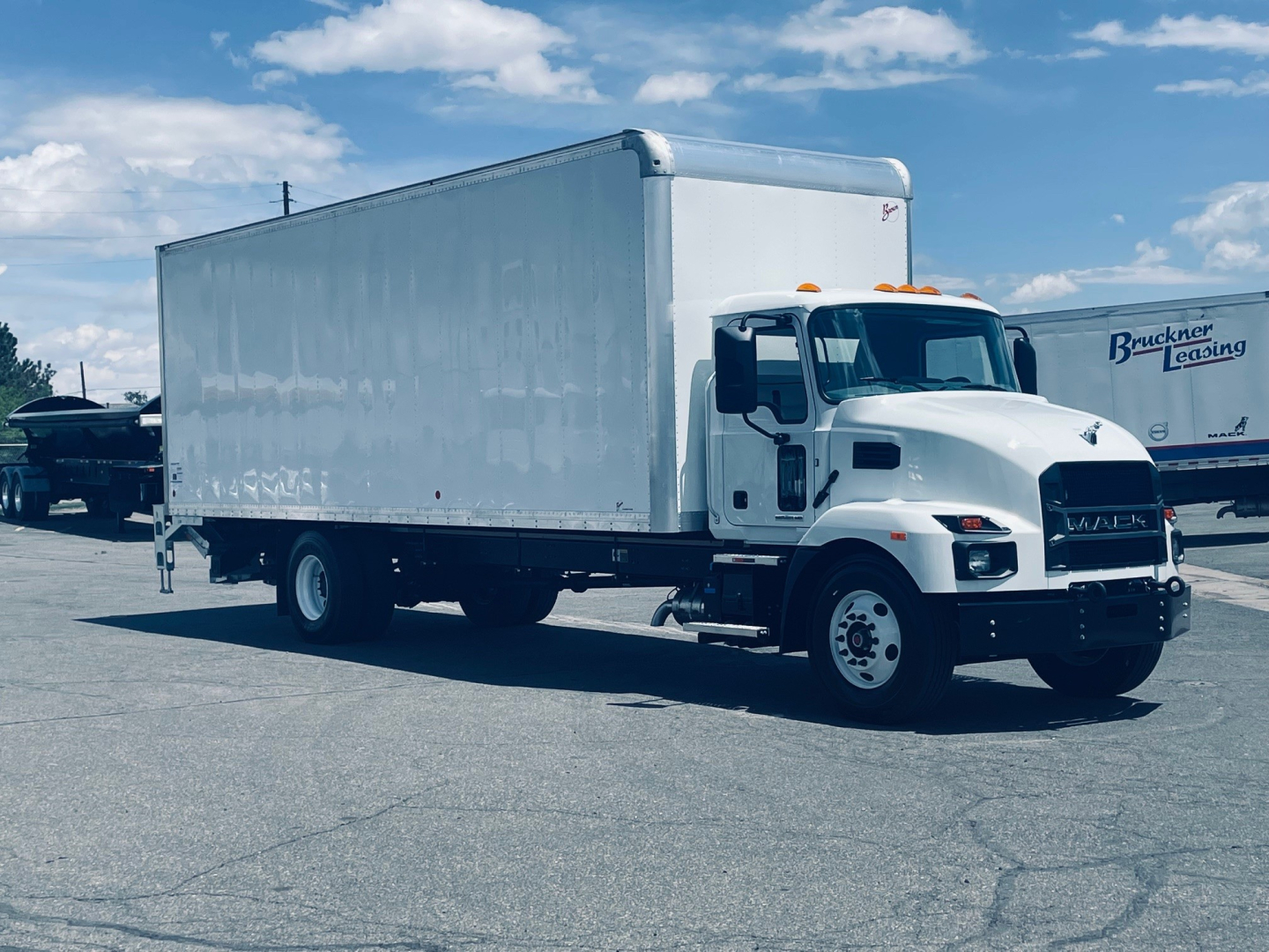 Box truck showing 2026 Mack MD6 in-service with a white cargo box and cab, side profile view
