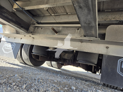 Trailer underside view of a 2019 Mac Drop Deck showing axles, wheels, and structural frame.