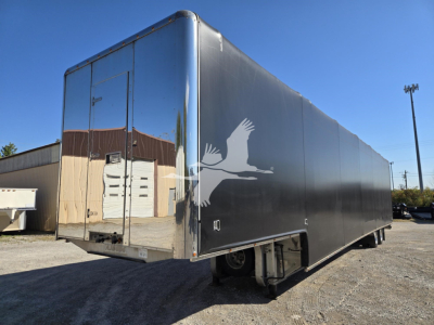 Mac drop deck trailer showing side and rear views with a bold graphic on the side and rear doors.