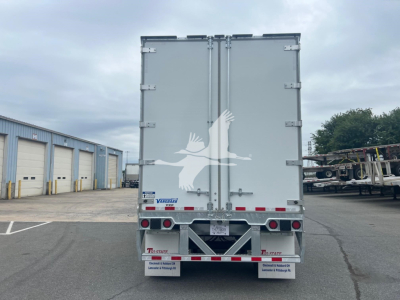 Rear view of a Vanguard VXP trailer with dual rear doors, reflective markings, and a small Vanguard logo plate visible.