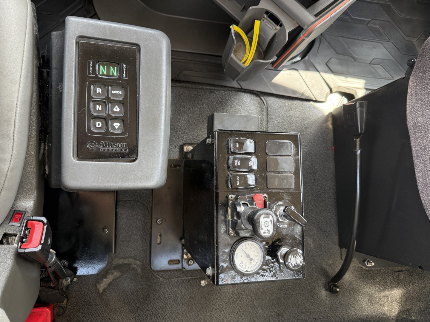 Volvo VHD truck interior showing gear shift panel and control console with multiple switches and gauges.