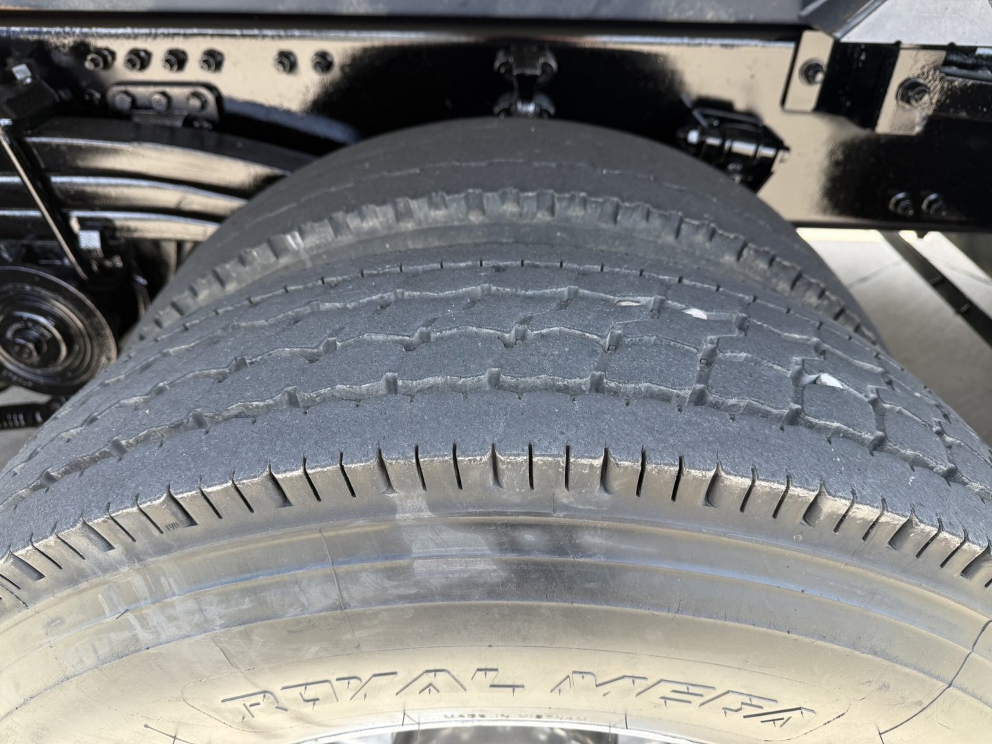Rear view of Volvo VHD104F300 dump truck showing tire tread and wheel well.