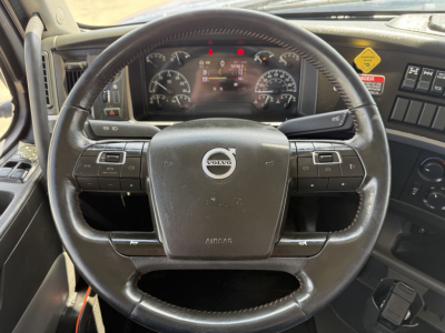 Volvo VHD steering wheel and dashboard view with instrument cluster and controls visible.