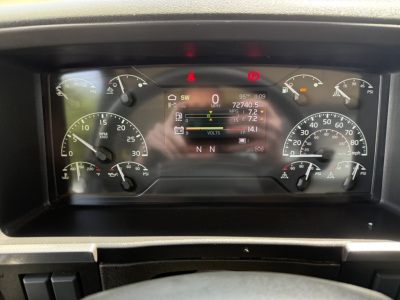 Dashboard cockpit of a Volvo VHD truck showing instrument cluster with digital display and multiple gauges.