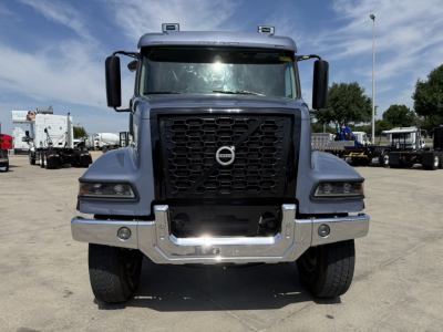 Volvo VHD truck front view showing grille with Volvo emblem, headlights, and chrome bumper.