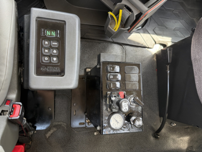 Volvo VHD truck interior showing gear shift panel and control console with multiple switches and gauges.