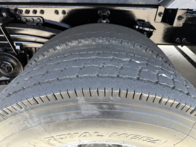 Rear view of Volvo VHD104F300 dump truck showing tire tread and wheel well.