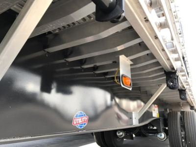 Utility 4000Ae Combo Flatbed trailer side view showing Utility logo and undercarriage details.