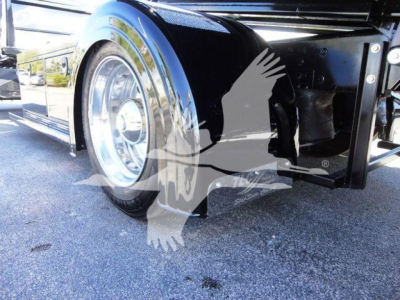Truck front fender and wheel well showing chrome wheel, bumper area, and undercarriage of a 2022 International MV rollback truck.