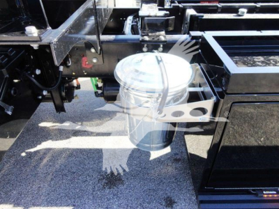 Truck rollback show metal frame and cylindrical fuel/air reservoir with bracket and hoses.