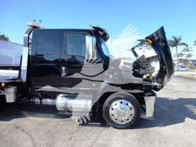 Truck cab side view with hood open, International MV Series truck, chrome fuel tanks, wheel, side steps.